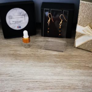 boucles d'oreilles doré en acier inoxydable et perle de lave noire