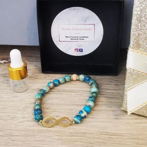 bracelet élastique perles bues apatite jade et signe infini doré en acier inoxydable