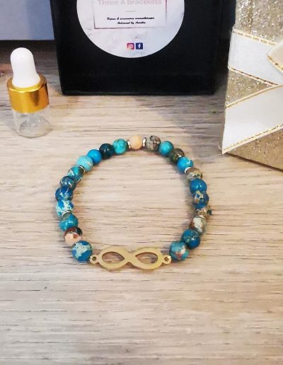 bracelet élastique perles jaune et bleu et signe infini doré en acier inoxydable
