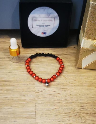bracelet enfant perles en verre rouge brillante, un grelot argenté en acier inoxydable et perle de lave noire 4mm